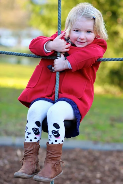 Preschooler girl having fun at playground — Stock Photo, Image