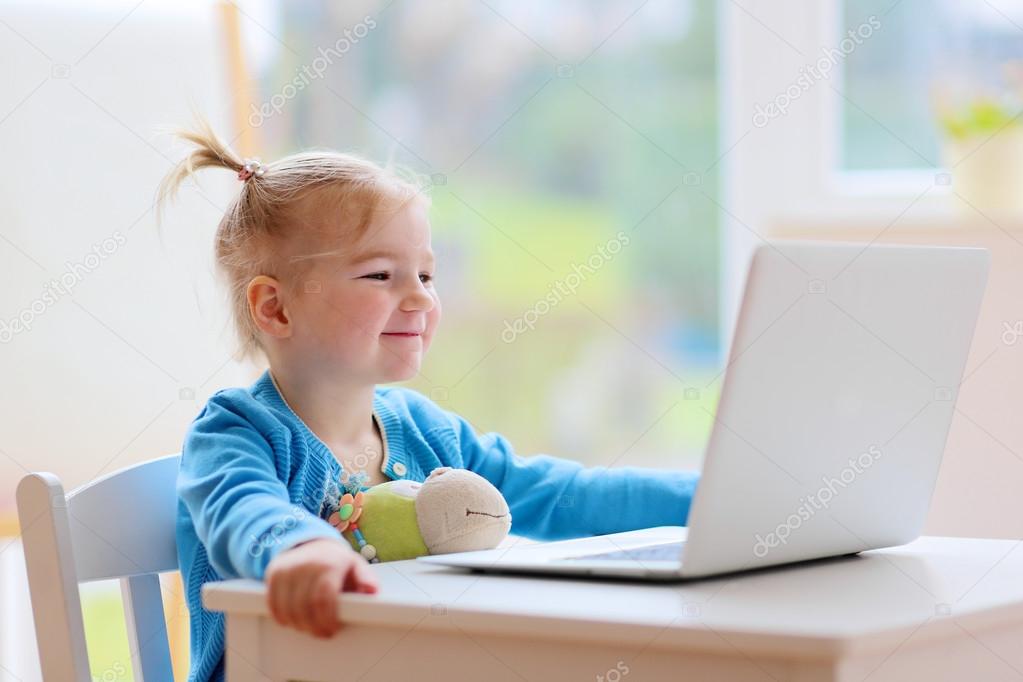 Little girl using laptop pc