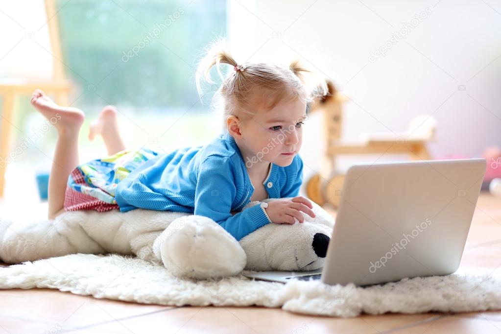 Little girl using laptop pc