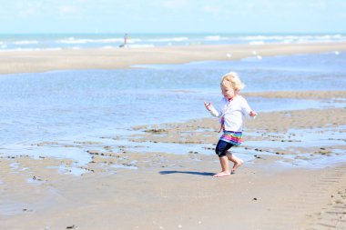 Kumsalda oynayan küçük kız.