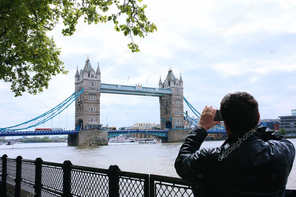 Tourists enjoying view of Tower Bridge, London