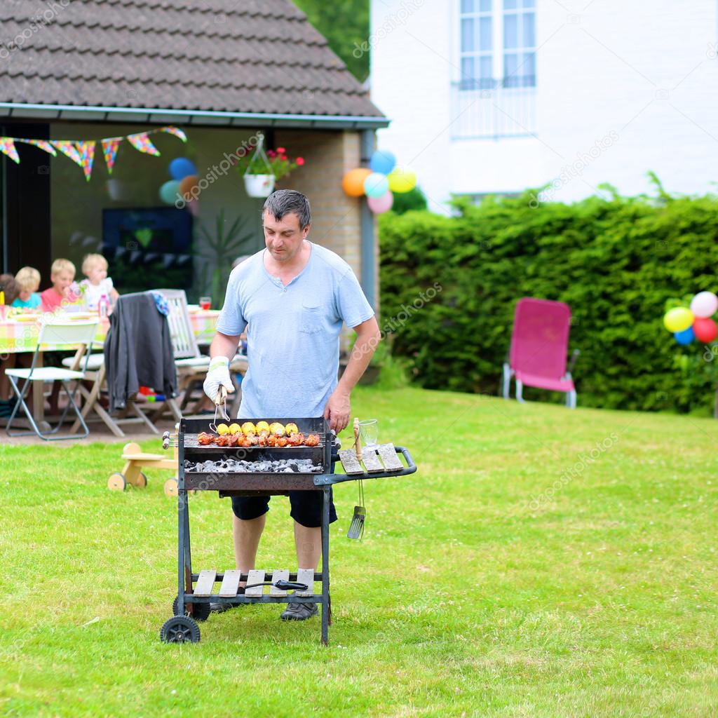 Man grilling meat outdoors