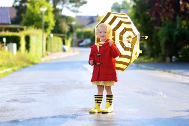 Portrait of playful little girl with colorful umbrella