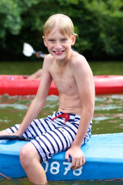 Active boy kayaking on the river