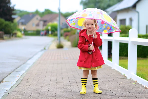 Portrait of playful little girl with colorful umbrella — 스톡 사진
