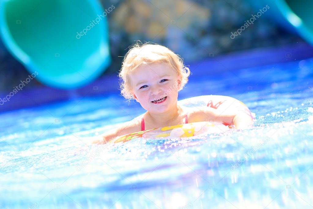 Healthy toddler girl in swimming pool