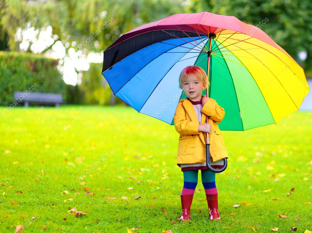 Portrait of playful little girl with colorful umbrella — Stock Photo © CroMary 79598058