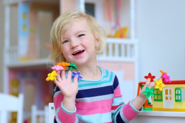 Preschooler girl playing indoors with educational toys