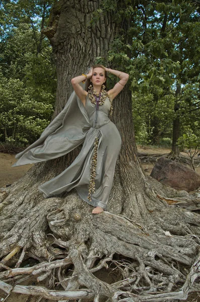 Jewelry made from shells of sea snails and sea shells, young woman in forest