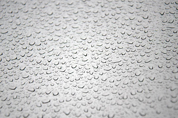 Gocce di pioggia su vetro - sfondo — Foto Stock