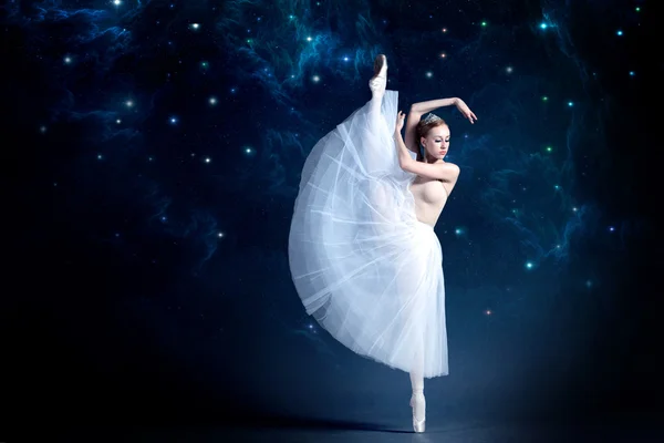 Young ballerina is dancing with the starry night sky in the background. — Stock Photo, Image