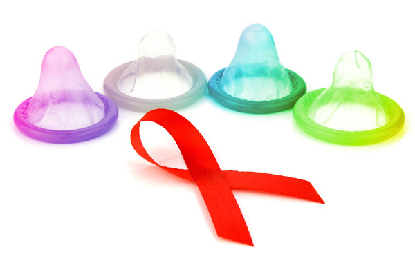 Red Ribbon Sign with Latex Condoms Background.