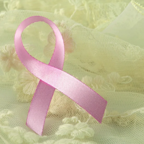 Breast cancer pink ribbon sign, breast cancer pink ribbon awareness on soft creamy background. — Stock Photo, Image