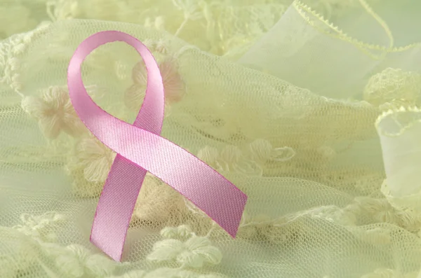 Breast cancer pink ribbon sign, breast cancer pink ribbon awareness on soft creamy background. — Stock Photo, Image