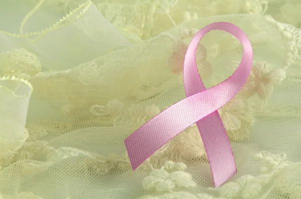 Breast cancer pink ribbon sign, breast cancer pink ribbon awareness on soft creamy background. — Stock Photo, Image