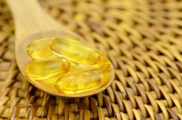 Spoonful of fish oil capsule. — Stock Photo, Image