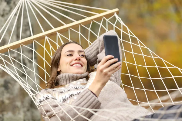 Щаслива Жінка Перевіряє Мобільний Телефон Лежить Гамаку Відпустці Восени — стокове фото