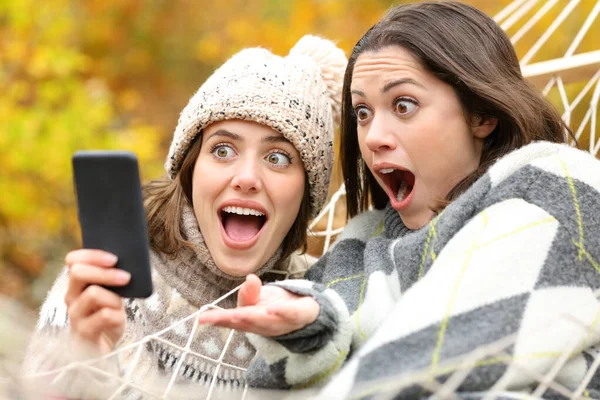 Two Surprised Friends Checking Smart Phone Content Together Autumn Holiday — Stock Photo, Image