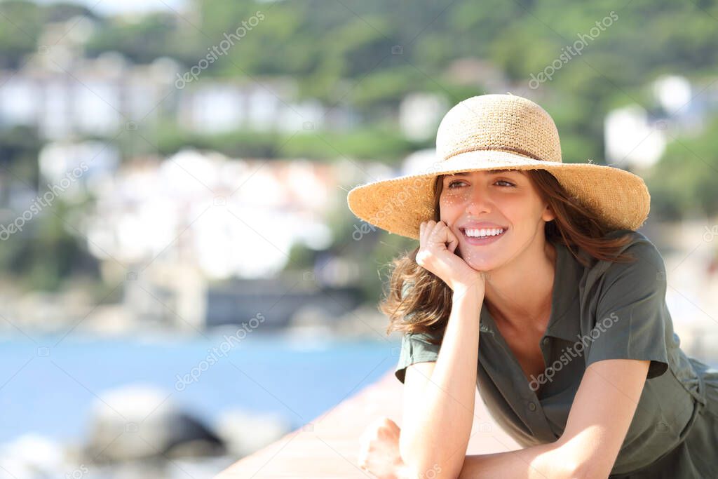 Happy woman with perfect smile on the beach on summer vacation