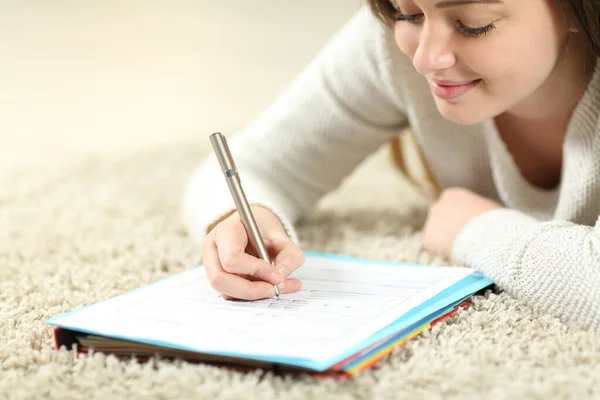 Satisfied Teen Filling Form Lying Carpet Home — Stock Photo, Image