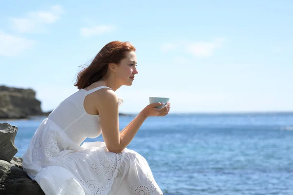 Profile Woman White Dress Drinking Coffee Contemplating Ocean Beach — 스톡 사진