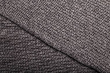 Gri kumaş dokusu, arkaplan ya da fon örgüsü. Tekstil, atkı ya da süveter desenli yüzey. Sıcak aksesuarlar, kıyafetler, moda konsepti.