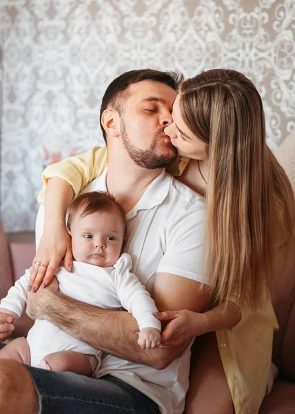 Genç ve güzel anne babalar birbirlerine kızak çektiler ve yeni doğmuş bir kız evlat tuttular.
