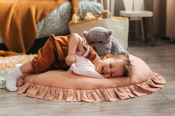 可爱的小女孩托德勒在孩子们的房间里和枕头玩耍 — 图库照片