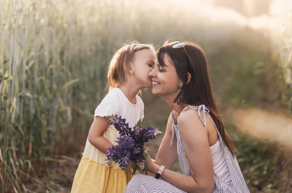 Little Girl Gives Bouquet Lupines Her Mother Field Summer Concept — Stock Photo, Image