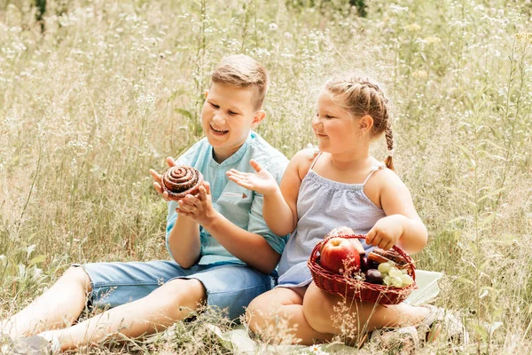 A boy and a girl at a picnic in the park. Overweight