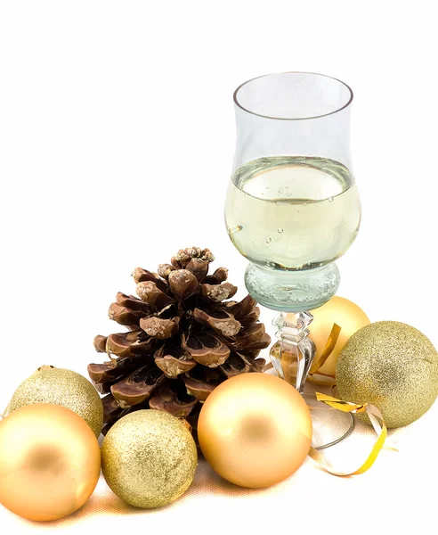 Glass of champagne with Christmas decorations on a white background — Stock Photo, Image