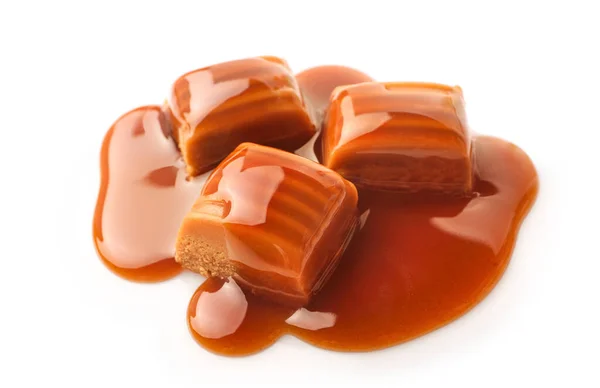 Caramel candies and caramel sauce isolated on white background.