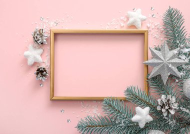 Noel ağacı dalları ve pembe arka planda noel süslemeleri olan çerçeve. Üst Manzara. Uzayı kopyala Noel indirimi kavramı.