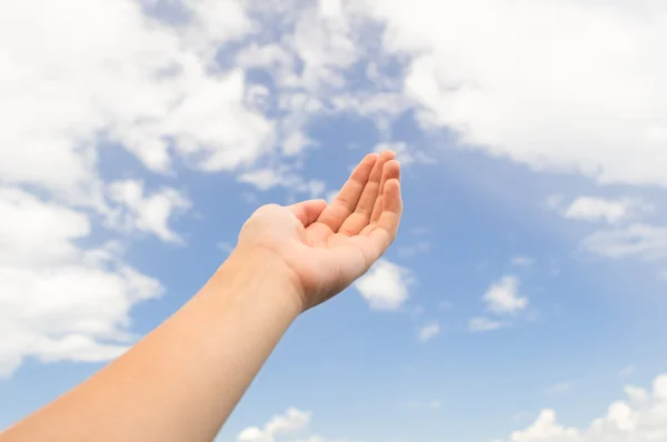 Empty hand palm on the blue sky with clouds — Stock Photo, Image