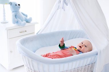 Cute baby in white nursery
