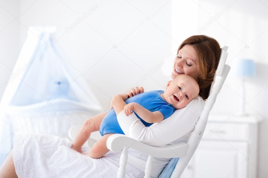 Happy young mother with baby boy at home