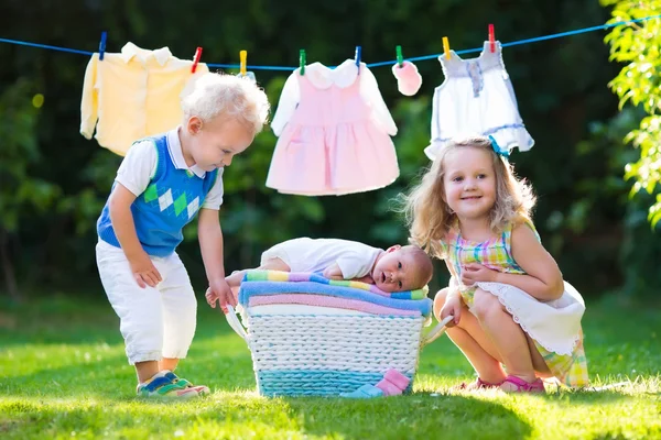 Kids playing with newborn baby brother — Stock Photo, Image