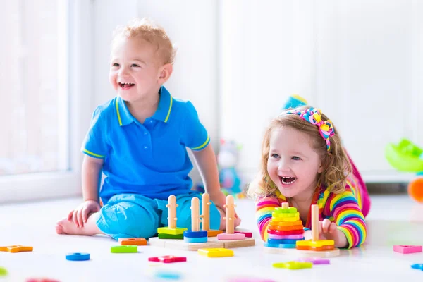Cjildren playing with wooden toys — Stock Photo, Image