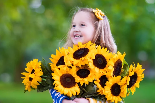 Little girl with sunflowers — Stock Photo, Image