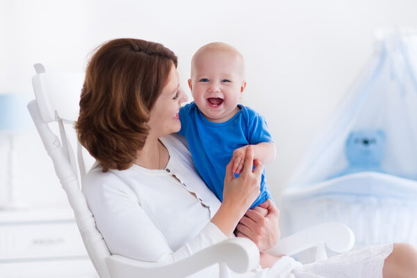 Happy young mother with baby boy at home
