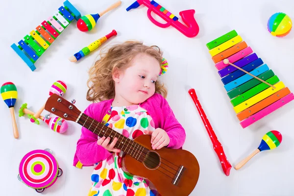 Little girl with music instruments — Stock Photo, Image