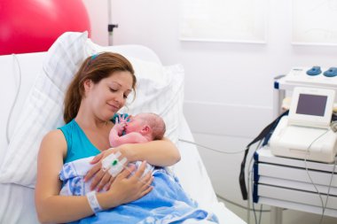 Young mother giving birth to a baby