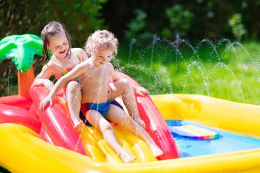 Kids playing in inflatable pool clipart