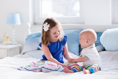 Anne yatakta oynayan çocuklar