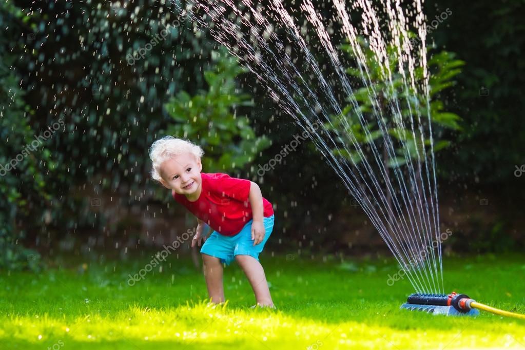 Kids playing with garden sprinkler — Stock Photo © FamVeldman ...