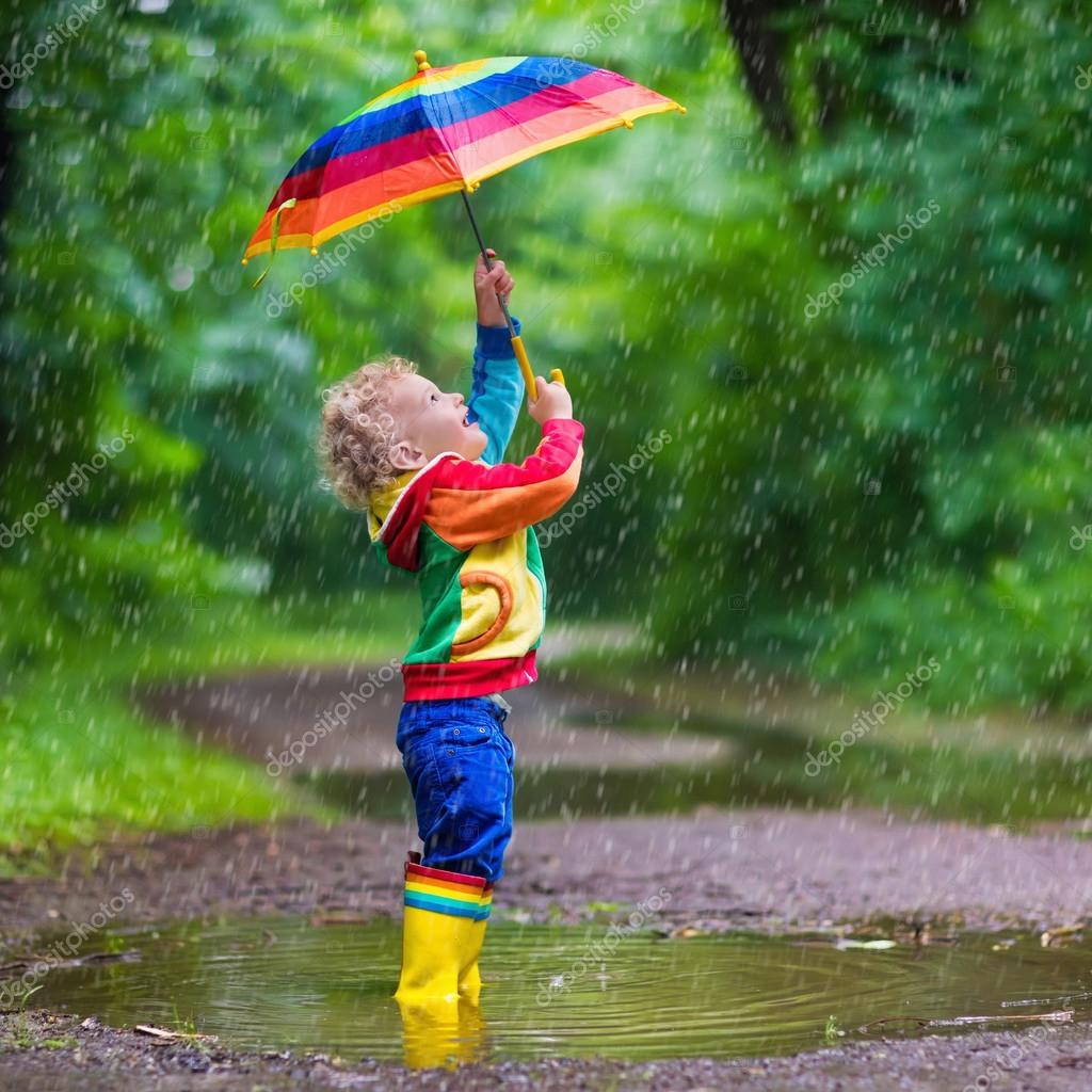 Child playing in the rain ⬇ Stock Photo, Image by © FamVeldman #111704120