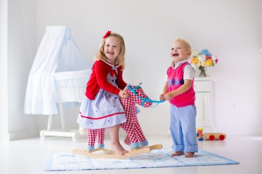 Kids playing with rocking horse