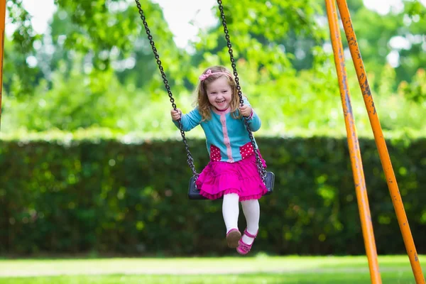 Klein meisje op Speeltuin Swing — Stockfoto