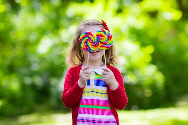 Menina com pirulito de doces coloridos — Fotografia de Stock