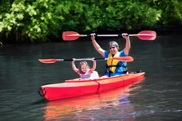 Father and child kayaking in summer